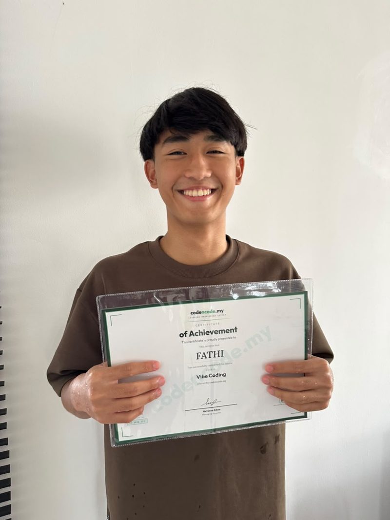Muhd Fathi holding a codencode.my Vibe Coding Certificate of Achievement